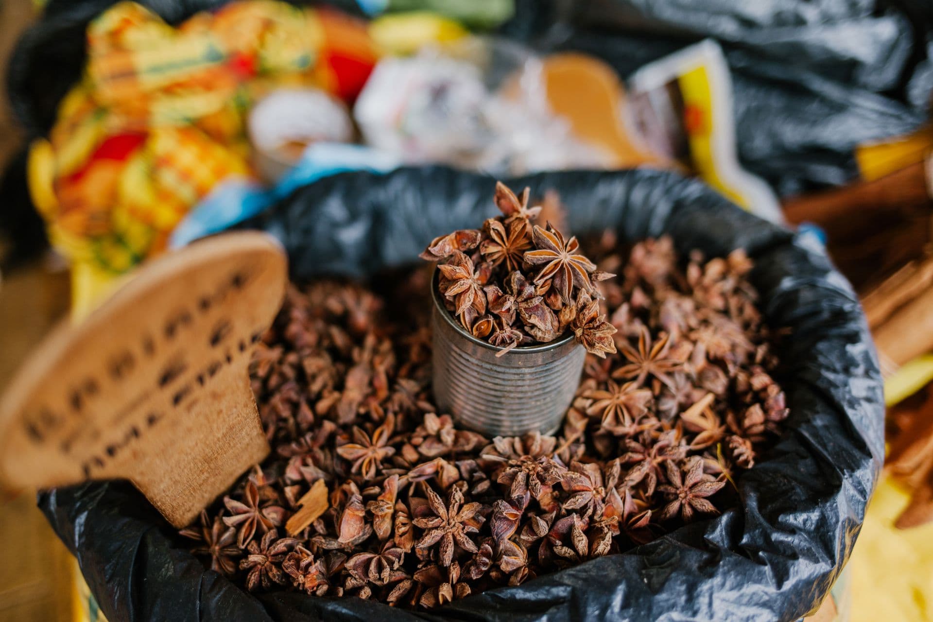 Star anise on open display in a tin at a market stall